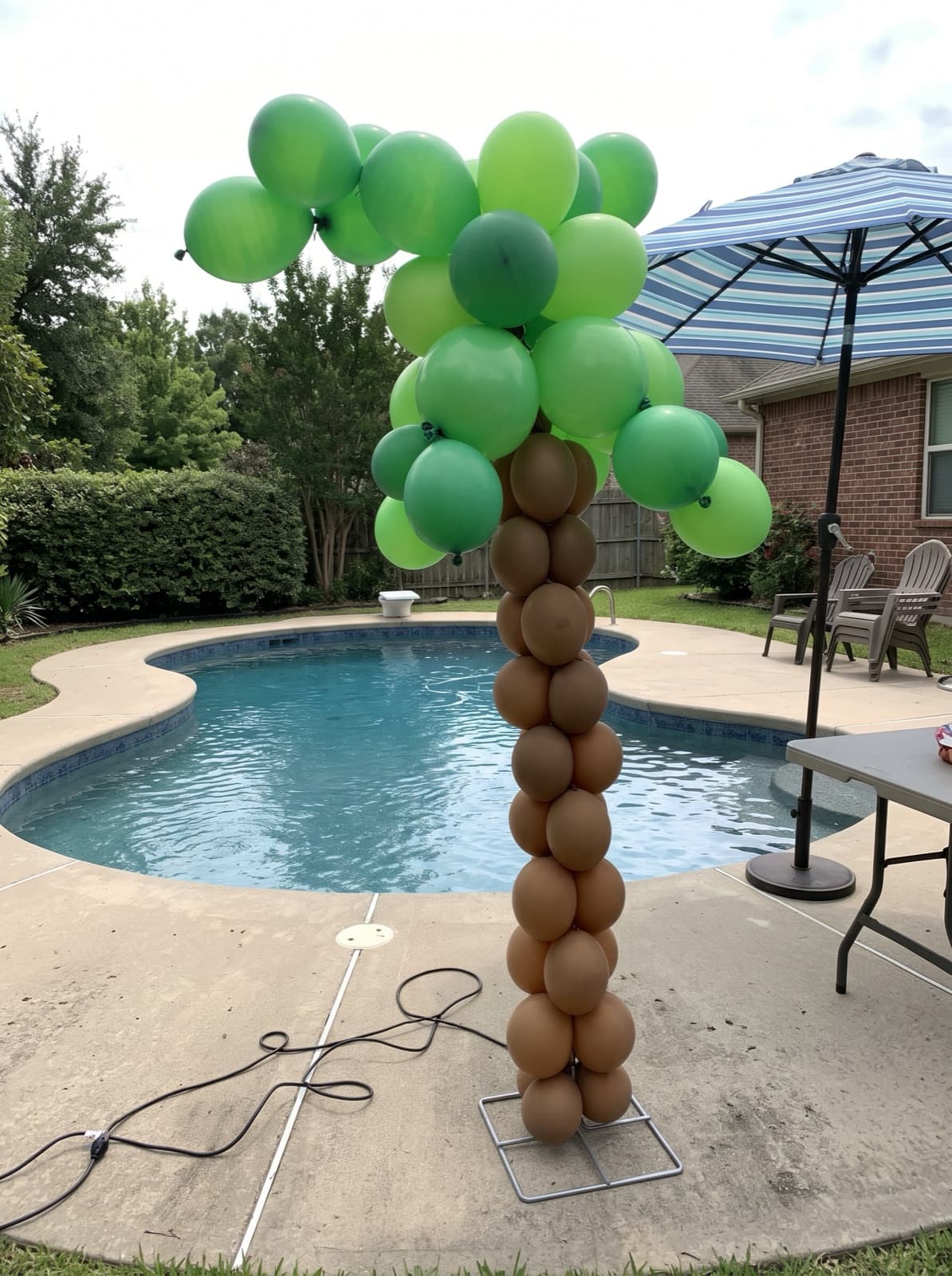 Palm tree balloon column at a pool party