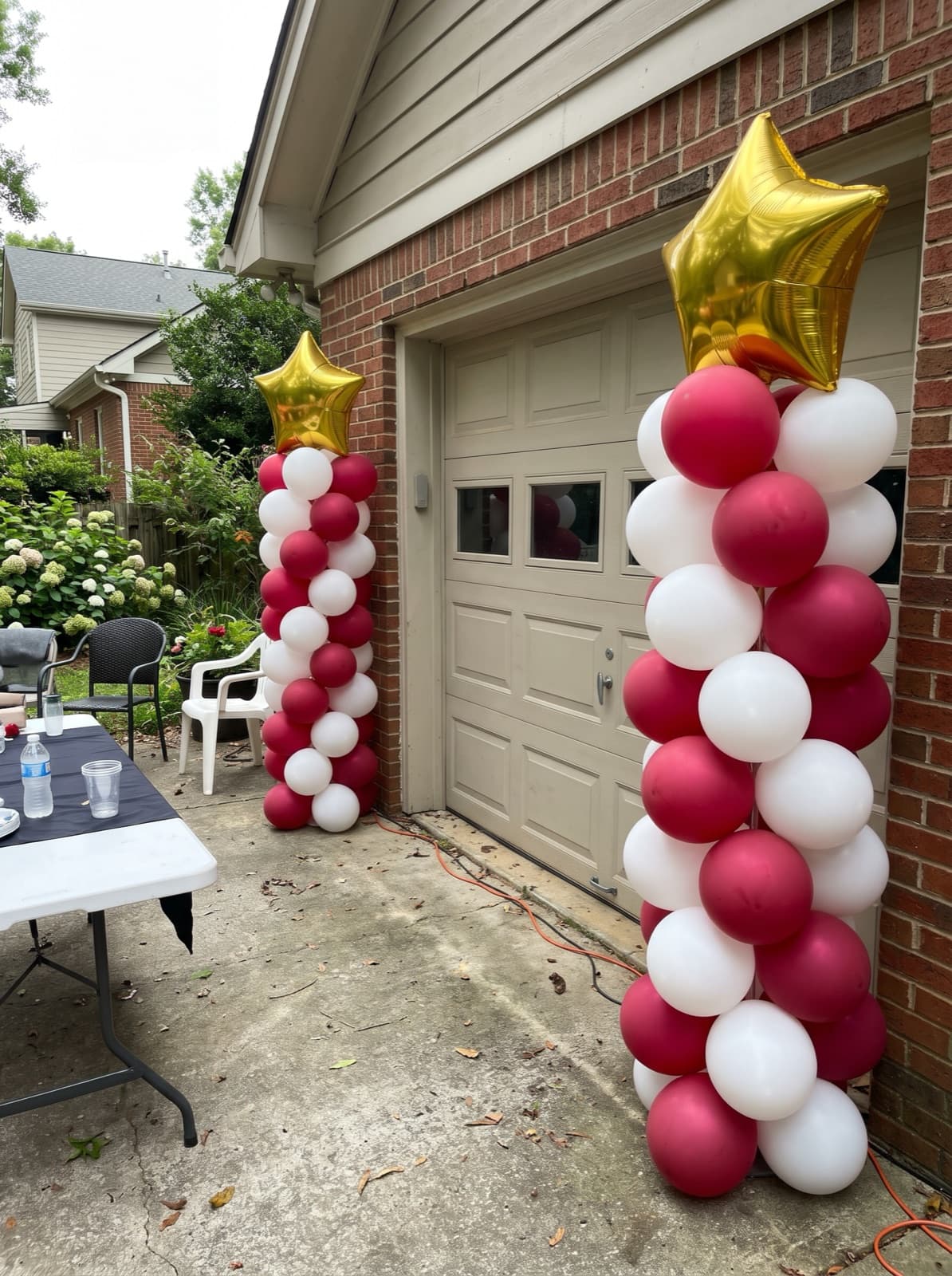 Balloon columns with gold star toppers for a graduation