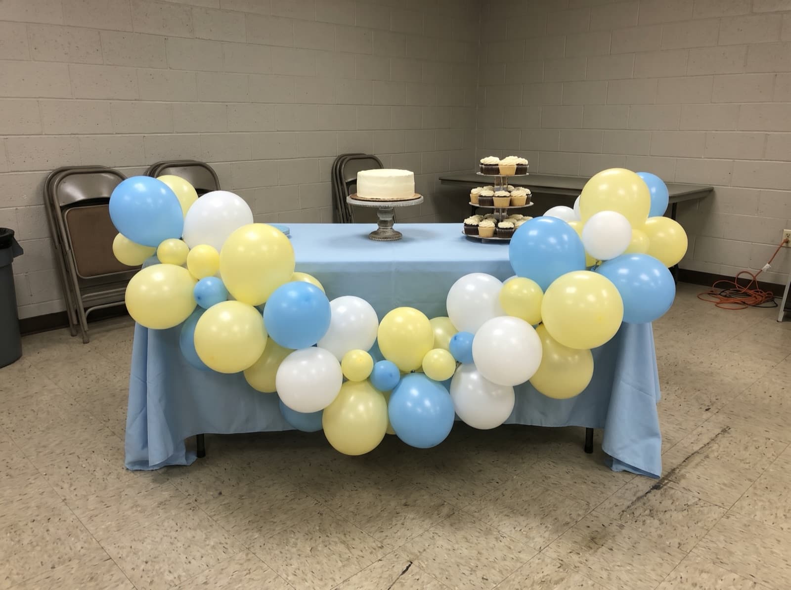 Balloon garland along the front of a cake table