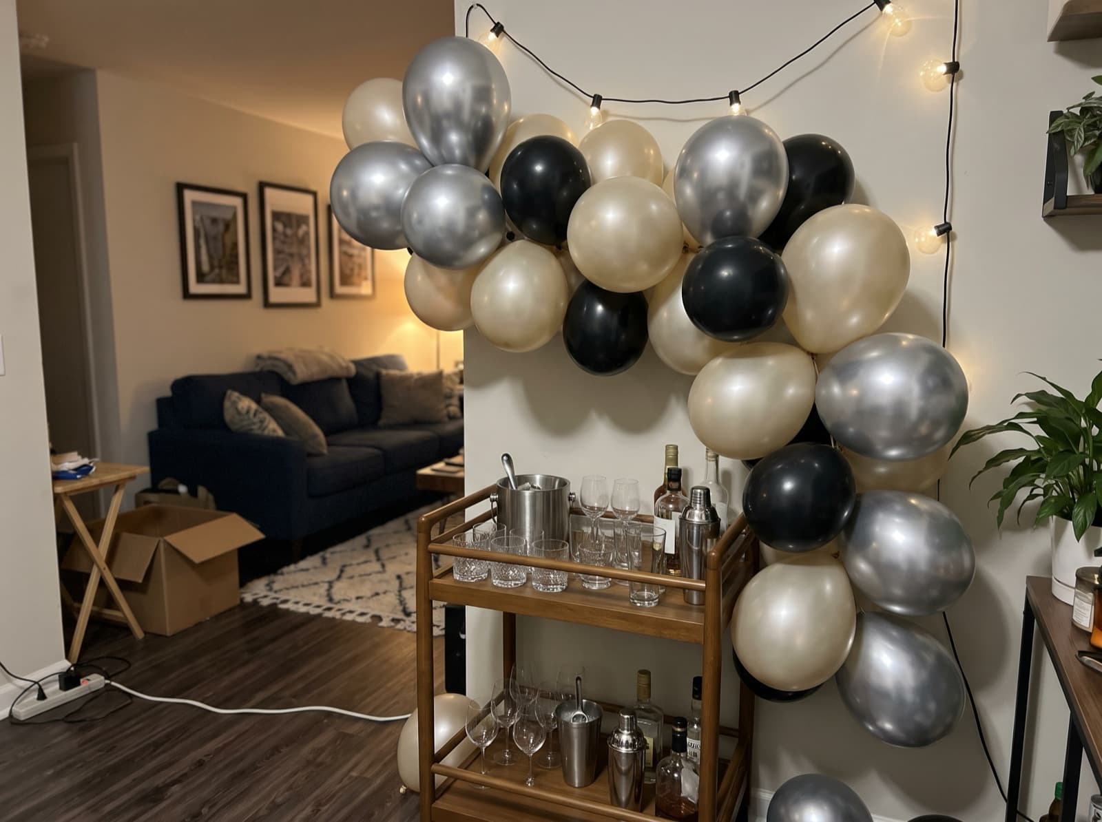 Chrome balloon garland over a bar cart for New Year's Eve