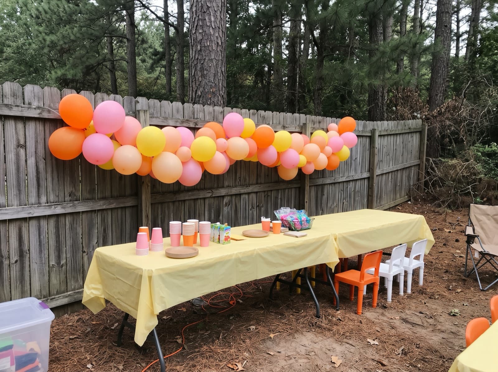 Balloon garland along a backyard fence