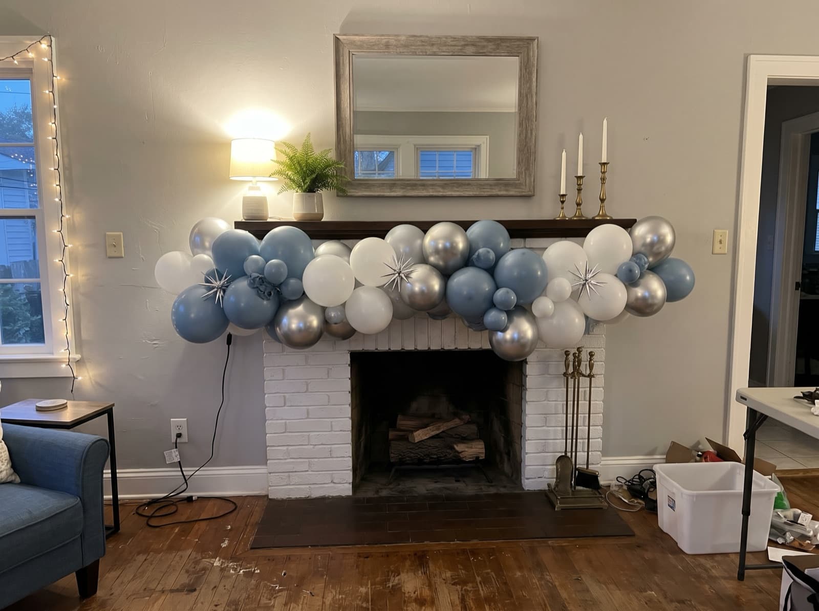Organic balloon garland in dusty blue, white and silver across a fireplace mantel in an Atlanta home