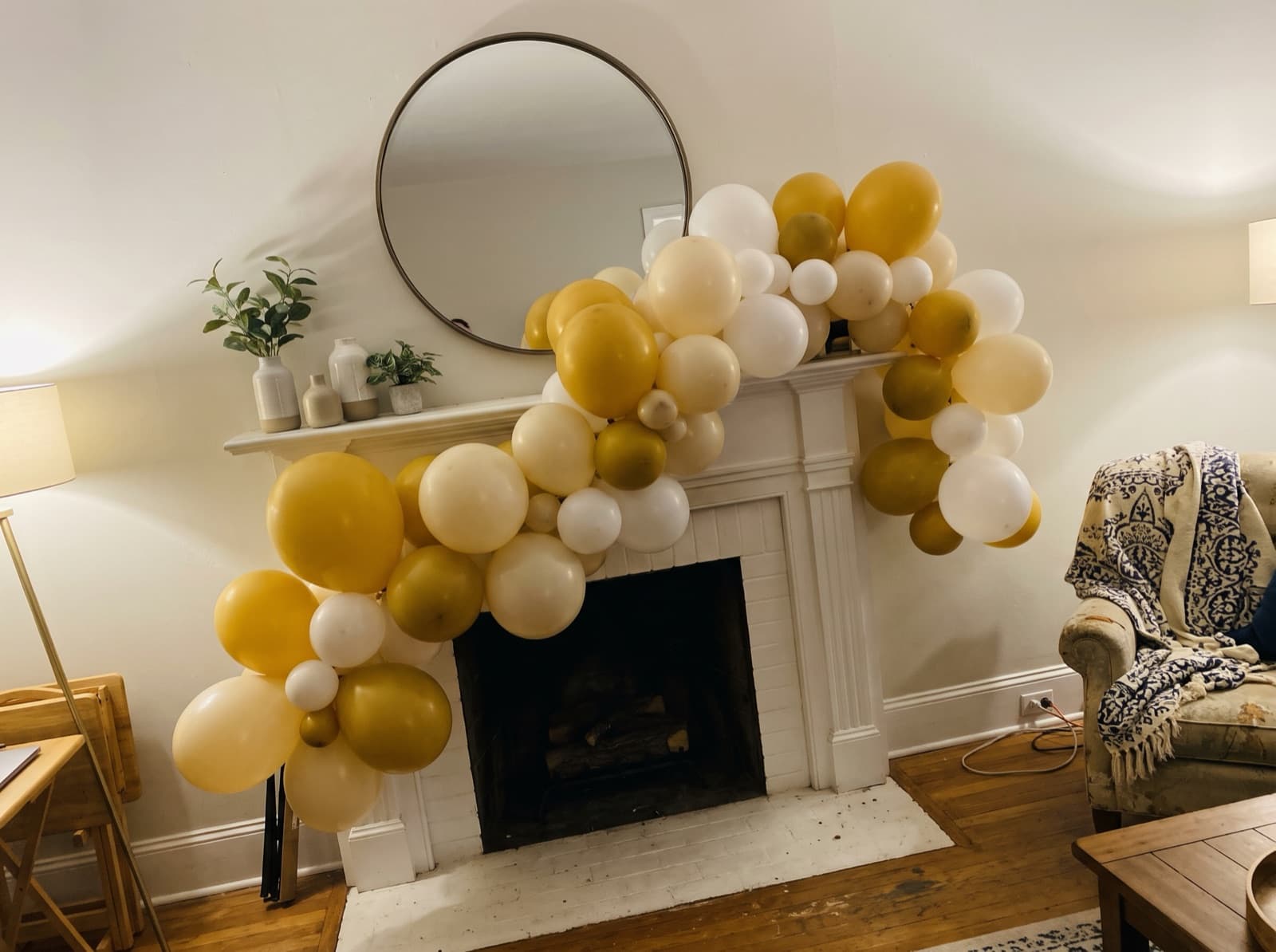 Organic balloon garland on a white painted mantel