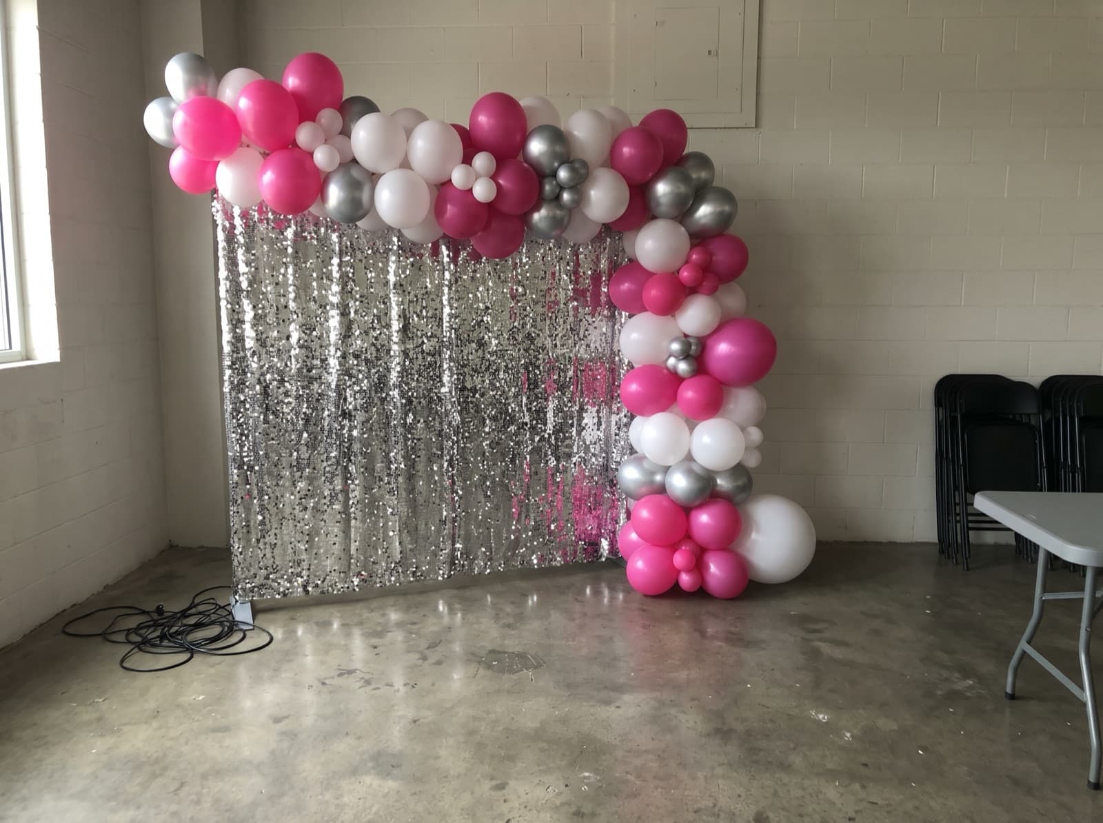 Balloon garland over a silver shimmer wall