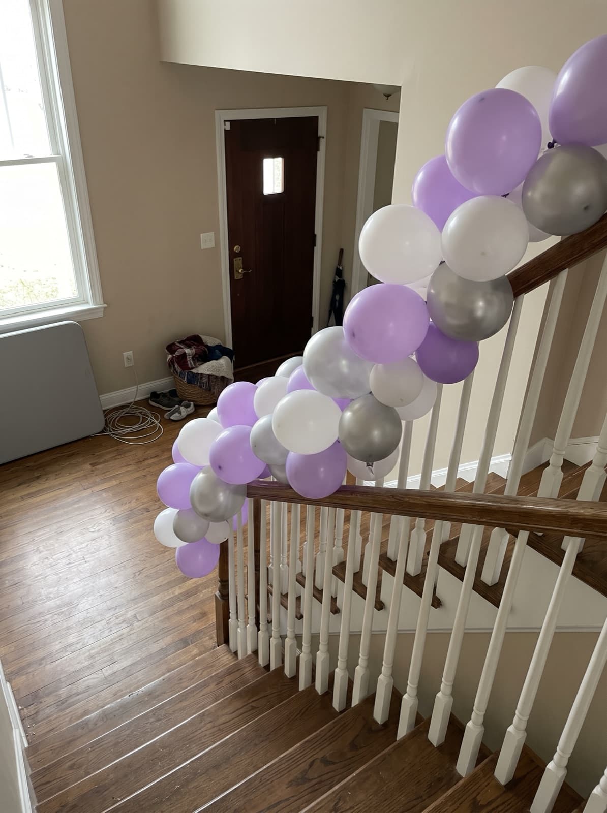 Balloon garland on a two-story foyer staircase
