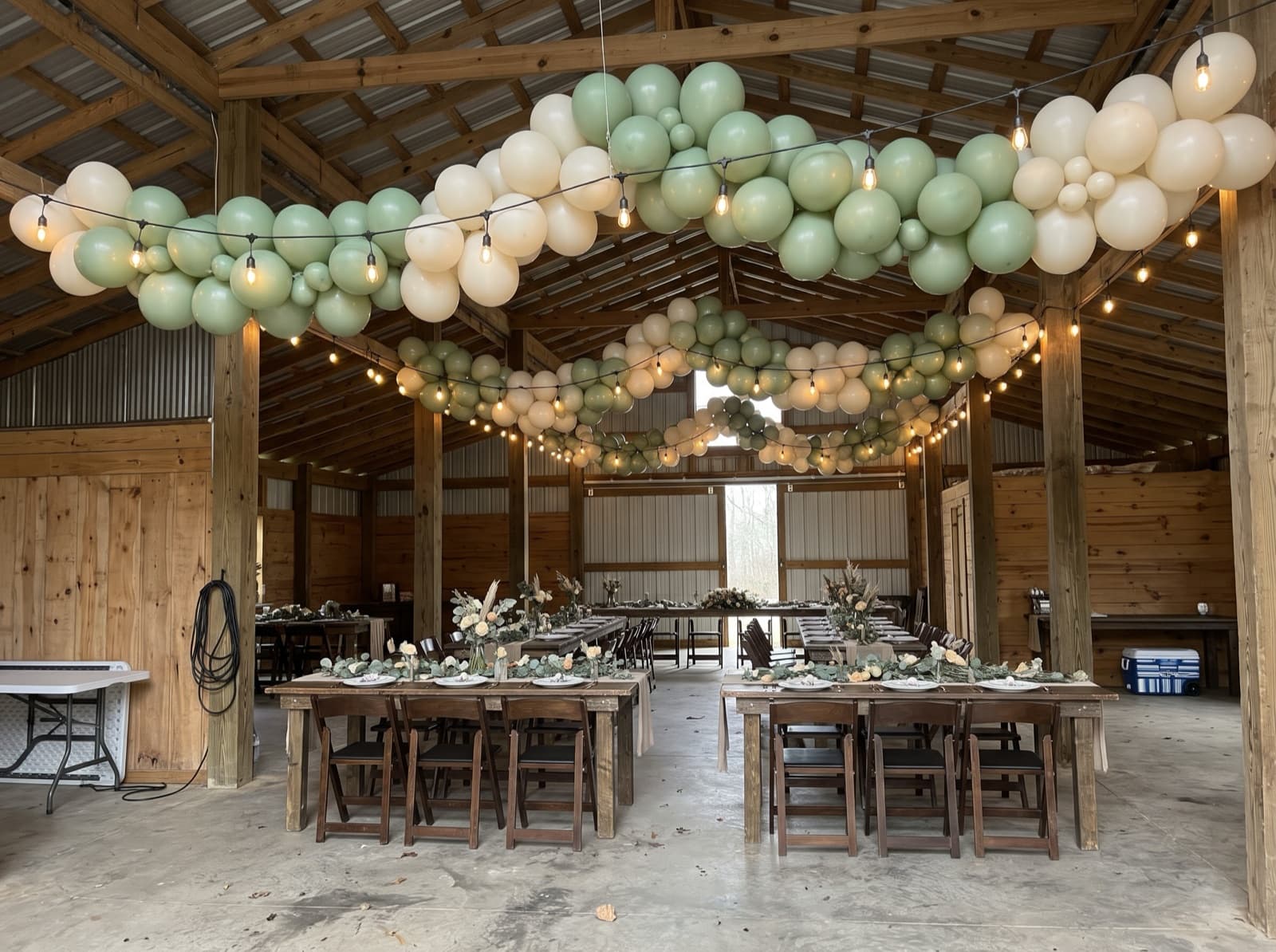 Hanging balloon garland canopy over dining tables