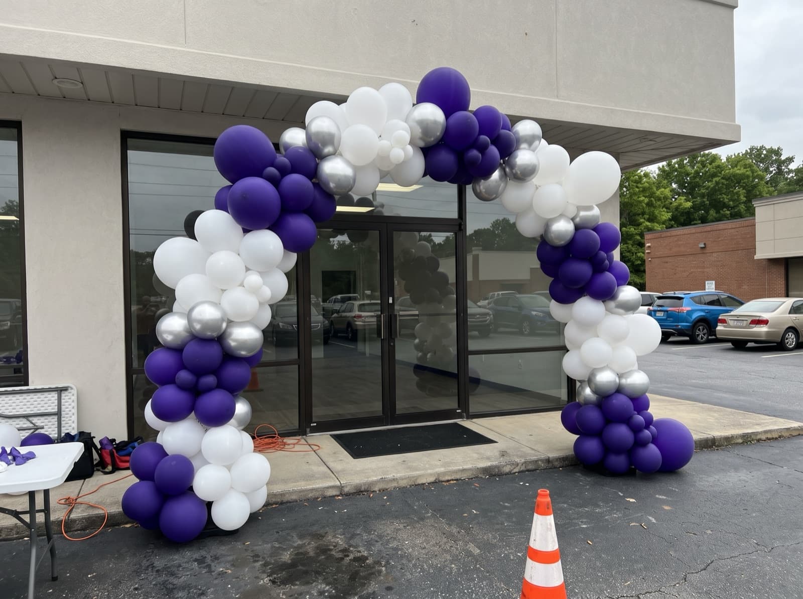 Giant balloon arch installation over a storefront