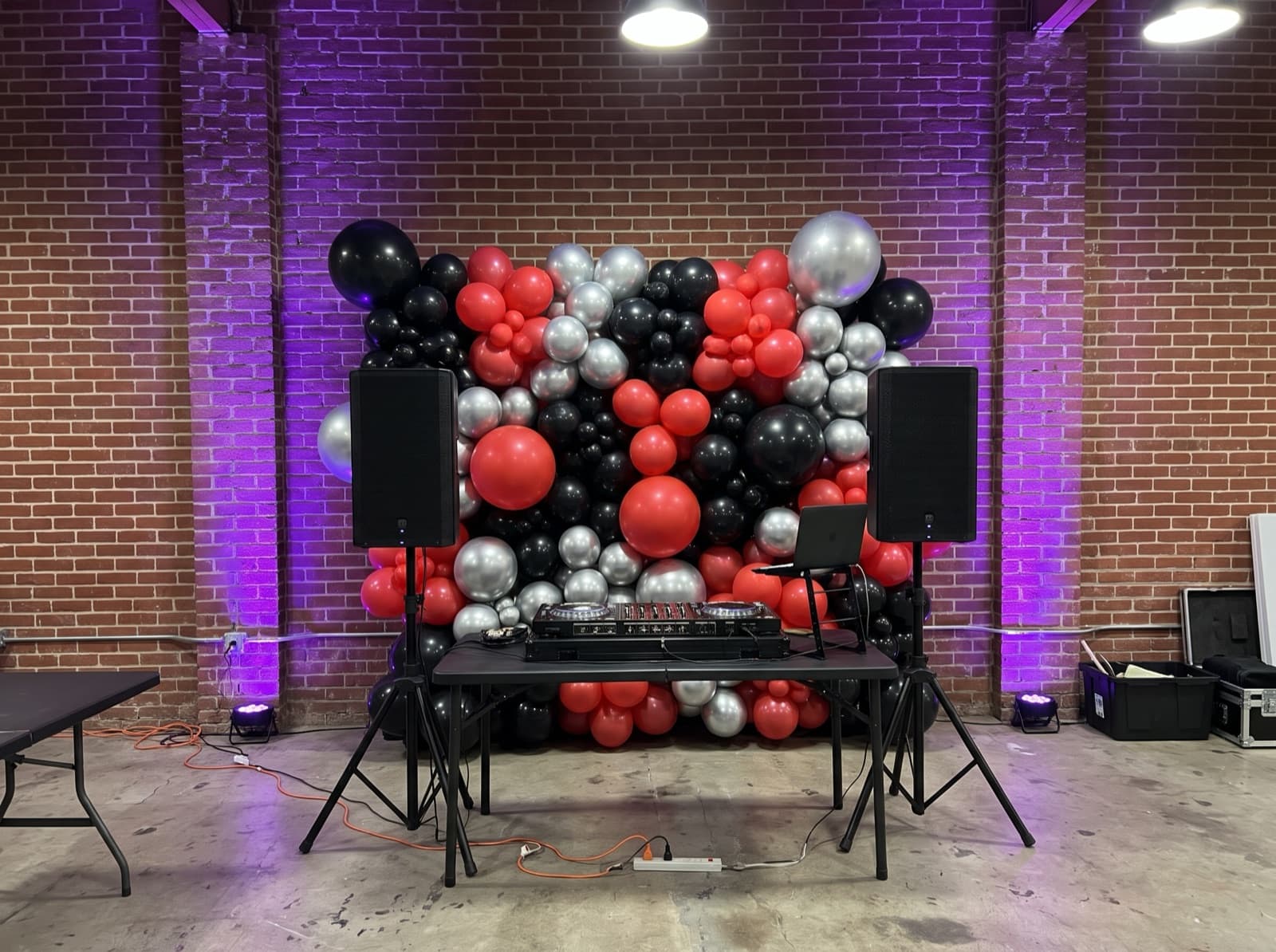 Balloon wall behind a DJ booth